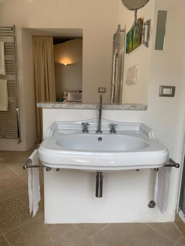 a white sink in a bathroom with a mirror at Casa di Carolina Italian Holiday Home in Pacentro