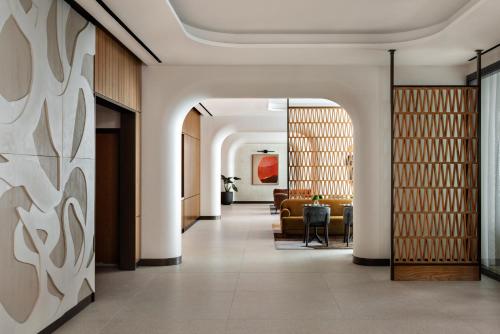 a corridor of a hotel with a lobby with a couch at Kimpton Theta New York - Times Square by IHG in New York