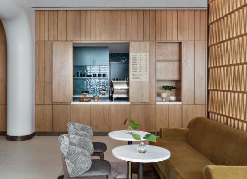 a living room with a couch and a table at Kimpton Theta New York - Times Square by IHG in New York