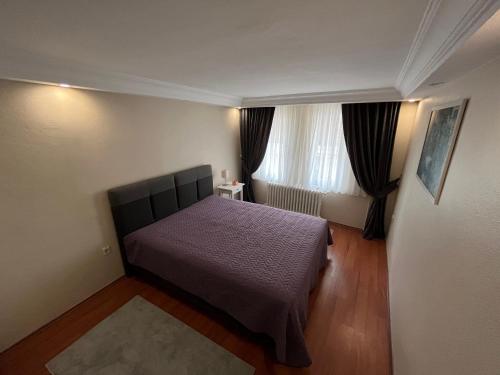 a small bedroom with a bed and a window at Urban Comfort in Nisantasi - Central & Spacious in Istanbul