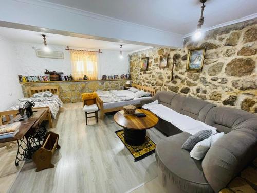 a large living room with a stone wall at Old House Kontic in Nikšić