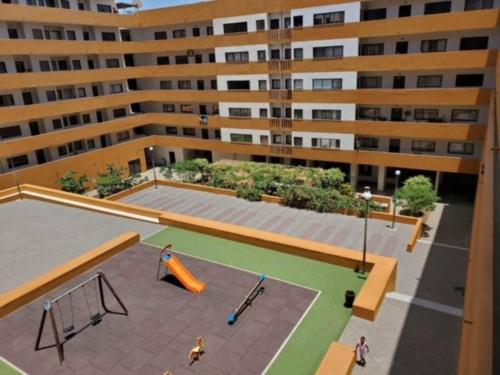 an aerial view of a building with a playground at Apartamento in Praia