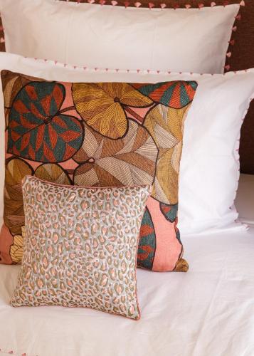 a bed with two pillows and a pillow on it at Riad Pompon in Marrakech