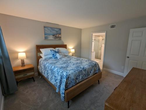 a bedroom with a bed with a blue comforter at NEW condo! Just 15 min to Ft Myers and Sanibel beach! Great Location!! in Fort Myers