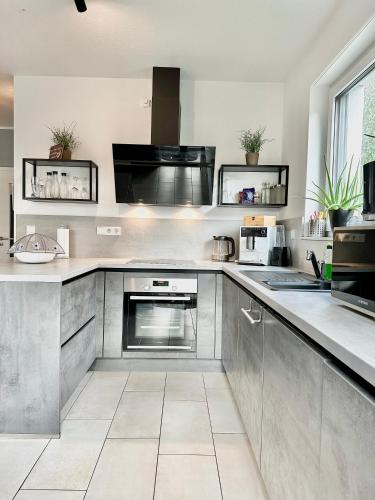 a kitchen with stainless steel appliances and a counter at Ferienhaus Oldenburg in Oldenburg