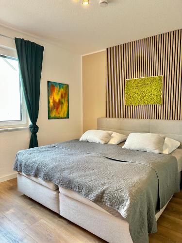 a bedroom with a large bed and a window at Ferienhaus Oldenburg in Oldenburg