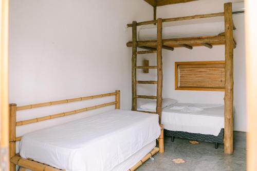 two bunk beds in a room with a ladder at Recanto Sole Luna in Maresias