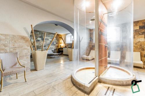 a bathroom with a shower and a tub at HOTIDAY Hotel Livorno in Livorno