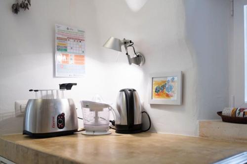 a kitchen counter with a blender and a toaster at Trullo Cristiana in Latiano