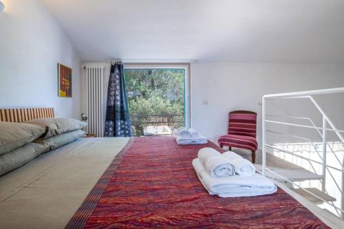 a living room with a couch and a red chair at Trullo Cristiana in Latiano