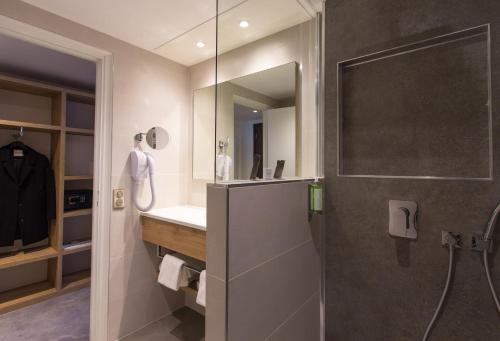 a bathroom with a shower and a sink at Hotel des Congrès in Villeurbanne