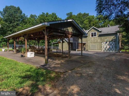 a pavilion in front of a house with a building at Barnhouse+1000sqft PartySpace for rent@Gainesville 