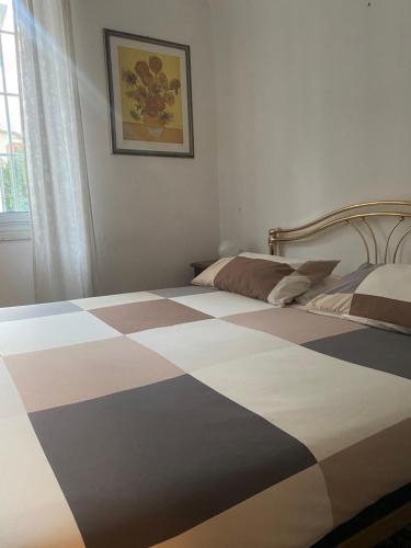 a bedroom with a bed with a checkered floor at LEONE VACANZE in Genoa