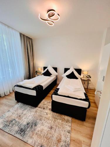 Krevet ili kreveti u jedinici u okviru objekta Nd Hotels & Apartments Oberstrasse Mülheim