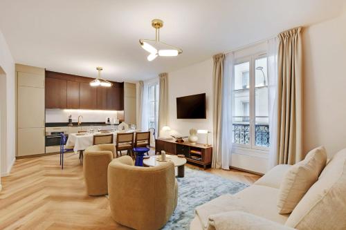 a living room with a couch and a table at Stunning fully renovated apartment 8P Paris 11 in Paris
