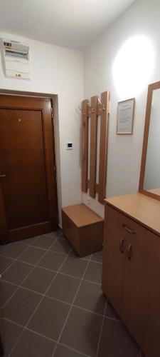 a bathroom with a closet and a door and a counter at Apartmán Janka in Oščadnica