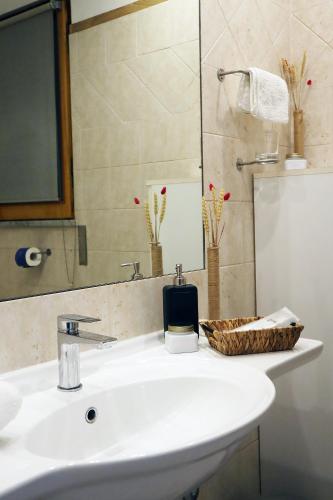 a bathroom with a white sink and a mirror at Villa Alba Boutique Hotel in Pescara