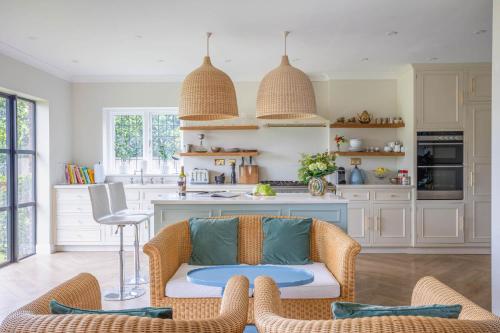 a living room with a couch and a kitchen at Riverbank house - Cookham in Cookham