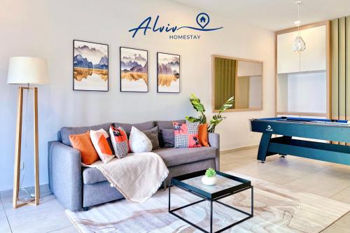 a living room with a couch and a piano at Atlantis Melaka I 5-11pax I 5min JonkerSt BY Alviv Management in Melaka