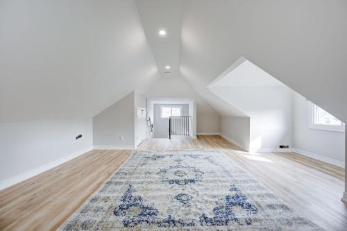 an attic room with a rug on the floor at Brand new 2 Bedroom plus Loft in Hamilton in Hamilton