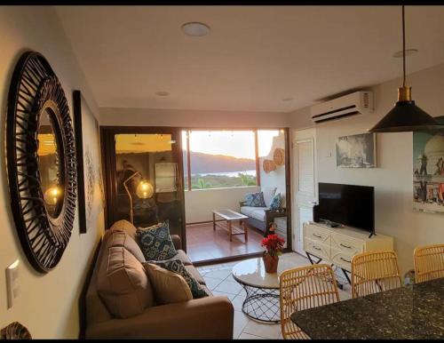 a living room with a couch and a table at Cozy Resort Beach Condo in Playa Hermosa in Sardinal