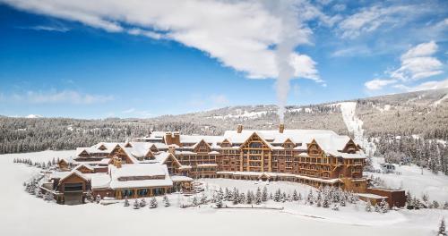 a ski lodge in the snow in the mountains at Montage Big Sky in Big Sky