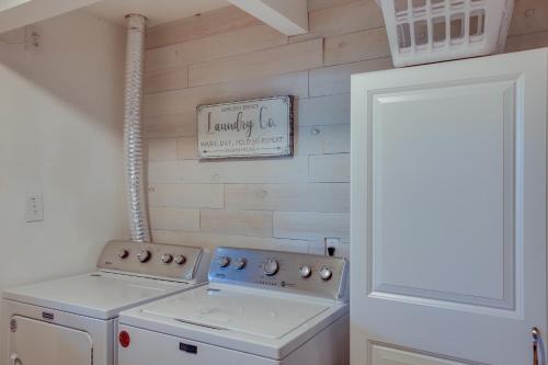 a kitchen with a stove and a sign on the wall at The InnLet - Comfy Cabin By Conkling Marina in Worley
