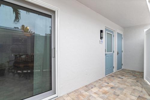 an empty hallway with a sliding glass door at Sea Foam - 173 in Siesta Key