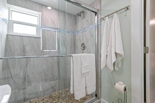a bathroom with a shower with a glass door at Sea Foam - 173 in Siesta Key