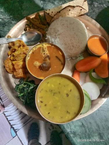 a plate of food with a bowl of soup and vegetables at Hotel ABC Pvt. Ltd. in Bhairahawa
