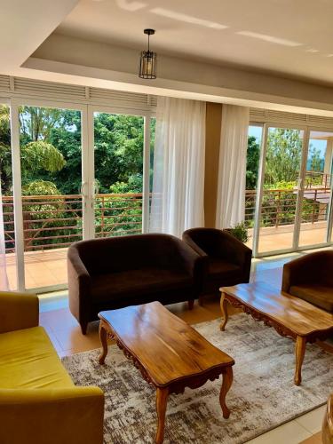 a living room with couches and a coffee table at The Address Resort in Kalangala
