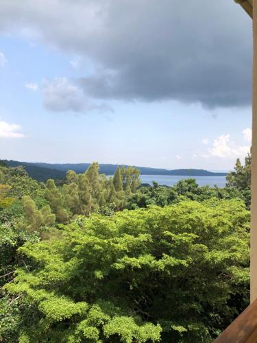 a view of trees and the ocean from a house at The Address Resort in Kalangala