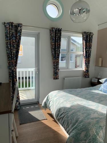 a bedroom with a bed and a large window at Chalet 283 in Bridlington