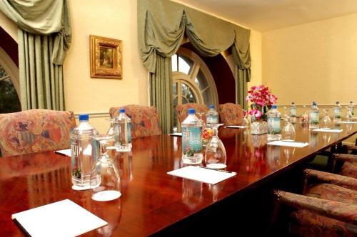 a long wooden table with glass bottles on it at The Brown Hotel in Louisville