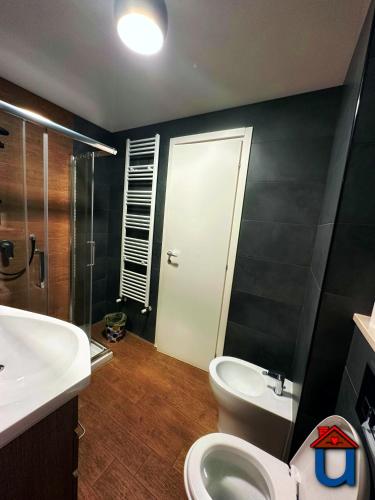 a bathroom with a toilet and a sink and a shower at Guest House La Maddalena in Foggia
