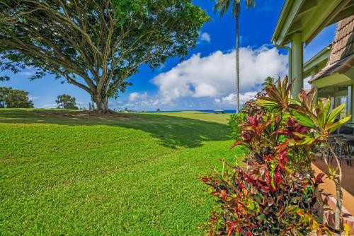 a house with a green lawn and a tree at Beautiful 2Br 2Ba Puamana, Ocean and Mountain View, Pool in Princeville