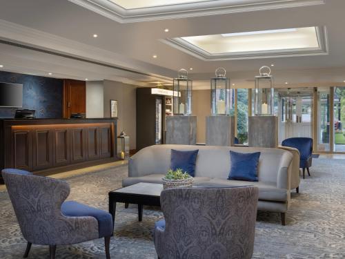 a lobby with a couch and chairs and a table at Delta Hotels by Marriott Worsley Park Country Club in Worsley