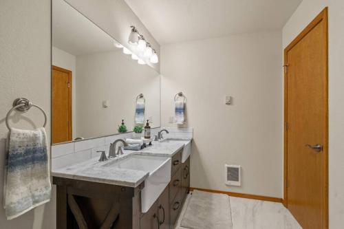 コー・ダレーンにあるMountain Home in Coeur d’ Aleneの洗面台が2つと大きな鏡があるバスルーム