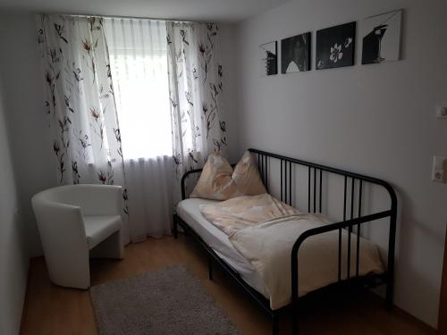 a small bedroom with a bed and a window at Anna in Dornbirn