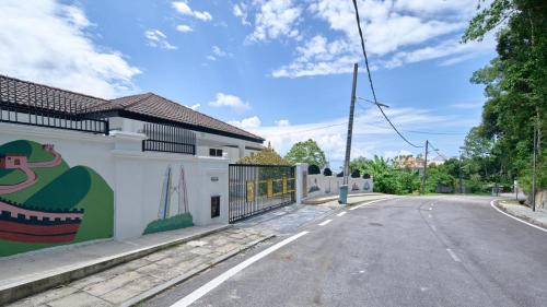an empty street with a mural on the side of a building at Penang Dream Banglo Sleeps 50 in Tanjung Bungah