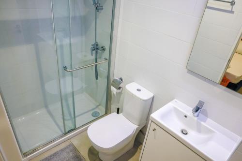 a bathroom with a toilet and a shower and a sink at Luxury Stay in Engomi