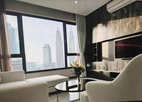 a living room with a white couch and a large window at 8 Kia Peng Suites KLCC by Luna in Kuala Lumpur