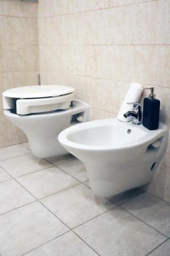 a bathroom with a toilet and a bidet at Villa Alba Boutique Hotel in Pescara