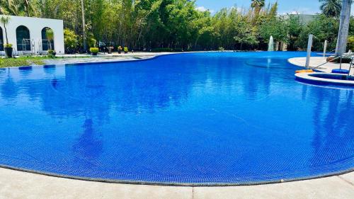 a large swimming pool with blue water at Your Luxury Oasis at Tahéima in Nuevo Vallarta 