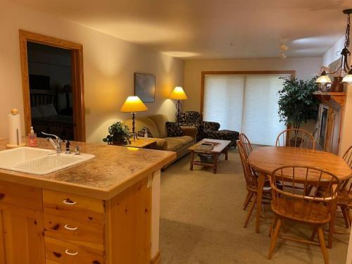 a kitchen and living room with a table and a couch at 2 Bedroom Condo - Blackfoot 313 in Driggs
