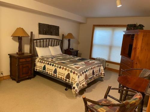 a bedroom with a bed and a chair and a window at 2 Bedroom Condo - Blackfoot 313 in Driggs