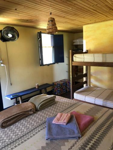a bedroom with two bunk beds and a window at Fazendinha da Canastra in Vargem Bonita