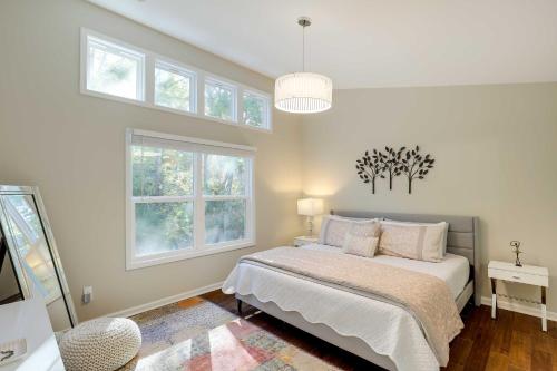 a bedroom with a bed and two windows at Luxury Mountain Home - by Ridgecrest and Asheville! in Black Mountain