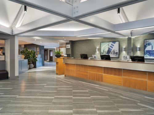 a lobby of a hospital with a reception counter at Delta Hotels by Marriott Manchester Airport in Hale