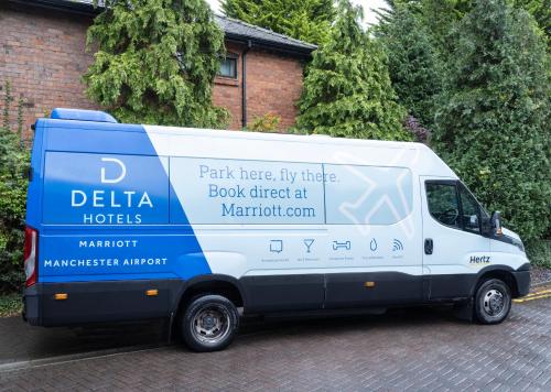 a van parked in front of a house at Delta Hotels by Marriott Manchester Airport in Hale